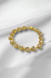 Golden bracelet with heart-shaped gemstones on a satin background