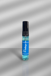 Small blue bottle with black cap on a reflective silver surface