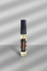 Small bottle of WARMAS perfume on a reflective silver surface with a gray background