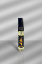 Small black bottle with a gold logo on a reflective silver background