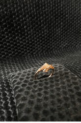 Gold ring on a textured black surface
