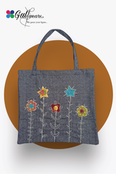 A gray tote bag with colorful floral hand work design