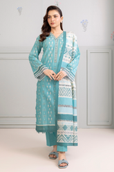 Woman wearing a teal and white patterned outfit against a light gray background