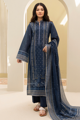 Woman wearing a blue embroidered traditional outfit with a dupatta in a bright setting