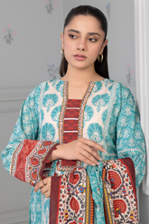 Woman wearing a traditional outfit with intricate patterns against a neutral background
