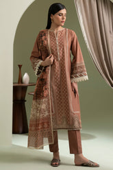 Woman wearing a patterned outfit standing in a room with a neutral color scheme.