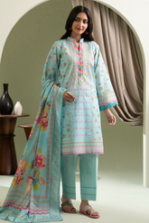 Woman wearing a light blue embroidered outfit with a floral dupatta in a decorated room.