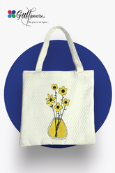 White Painted floral Tote Bag displayed on blue circle, white back ground.