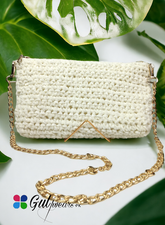 A white wool clutch bag with a spacious design and an elegant golden chain.