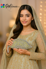 Woman in a traditional outfit holding a decorative clutch with 'Gulfeavors PK' branding.