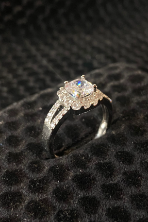 Diamond ring on a black textured surface