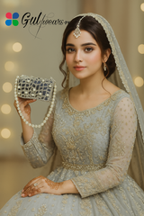 An off-white clutch bag with pearl accents and intricate Gotta work, holding a beautiful girl.