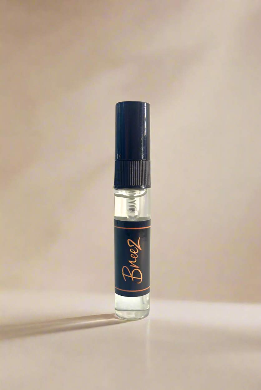 Breeze small perfume bottle with a blue label on a gray background