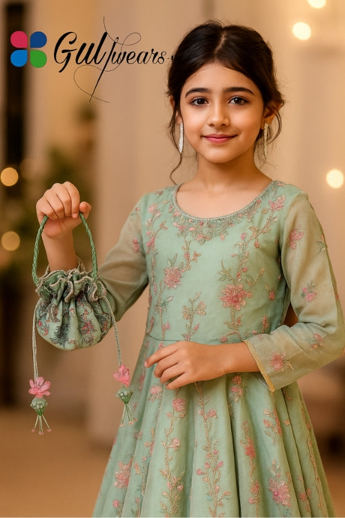 Young girl in a floral dress holding a matching bag with 'Gulwears' branding.
