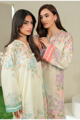 Two women wearing floral embroidered shirts outdoors.