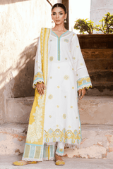 Woman wearing a traditional outfit with white and yellow patterns, standing outdoors.