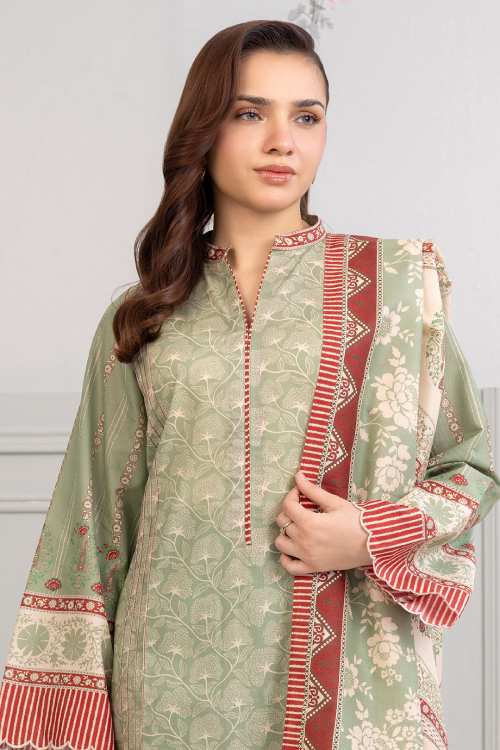 Woman wearing a traditional outfit with green and red patterns on a plain background